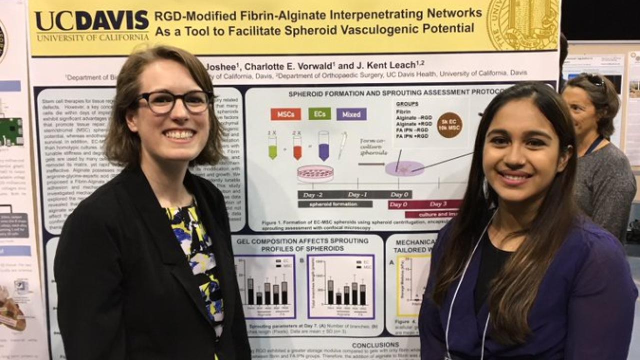 Charlotte and Shreeya stand in front of Shreeya's poster