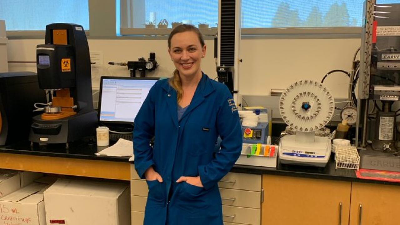 Jackie poses in lab after being given the Outstanding Graduate Student award