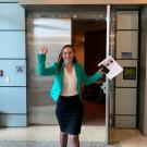 Jackie exits the lecture hall where she defended her dissertation defense